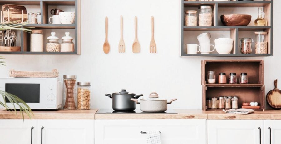 Kitchen with white cabinets and wall stoarge