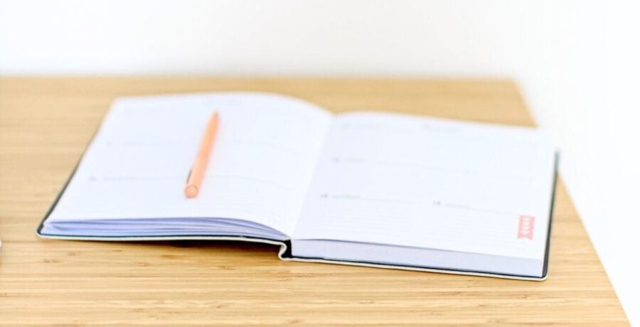 Planner lying open on a wooden desktop